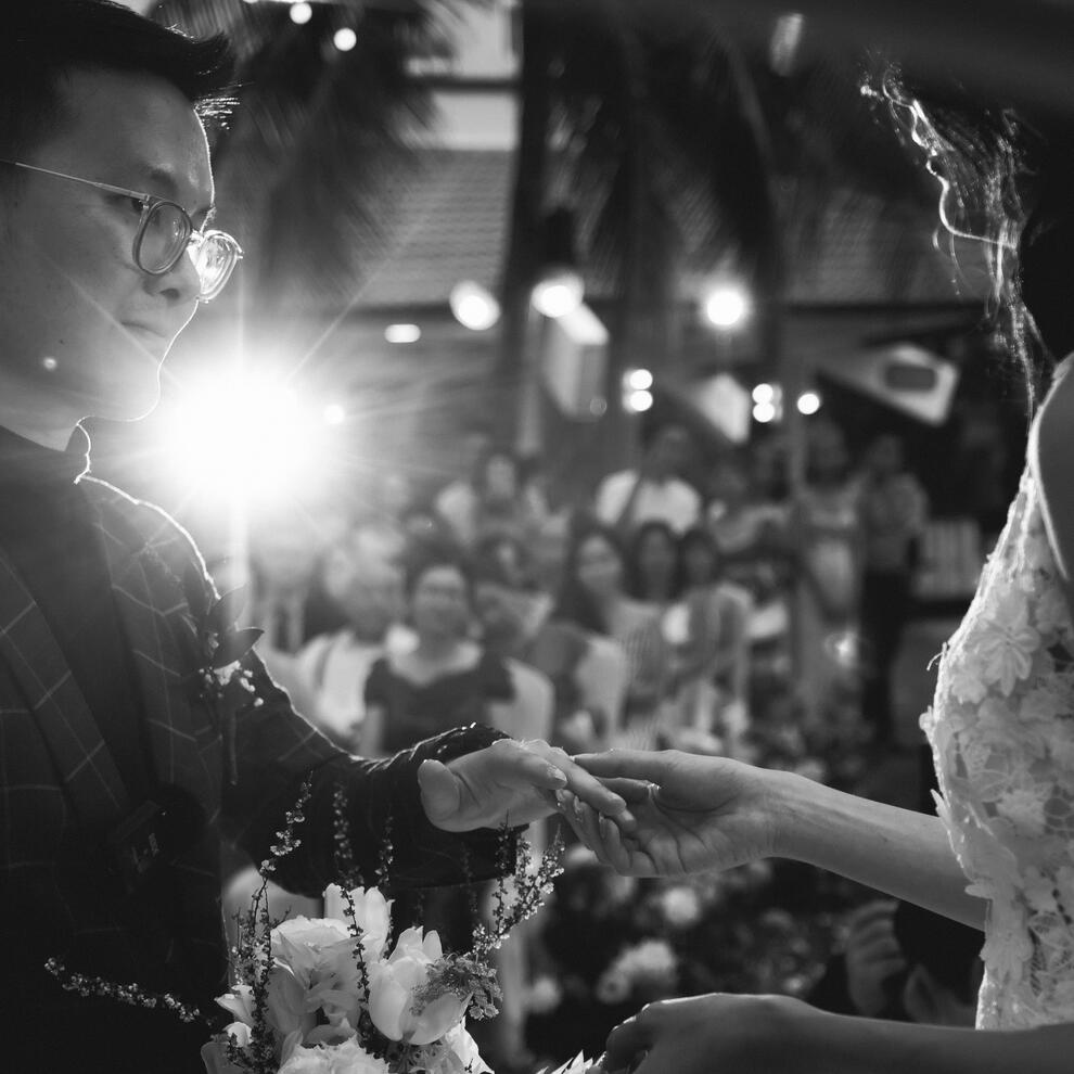Black-and-white photo of Kenz Tran in a wedding ceremony, highlighting the balance of personal life and leadership in building an AI startup.