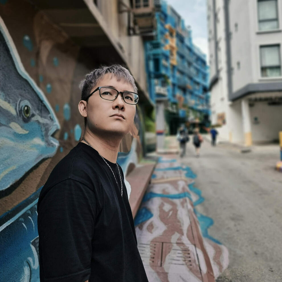 Artistic portrait of MOCHIMIN CEO Kenz Tran against a Saigon mural backdrop, symbolizing the intersection of street culture and creative AI entrepreneurship.